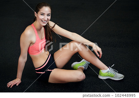 You can do it. an athletic young woman sitting indoors. You can do it. an athletic young woman sitting indoors. 102448995