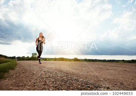 Ill never stop moving. a fit young woman out for a run on a beautiful day. Ill never stop moving. a fit young woman out for a run on a beautiful day. 102449033