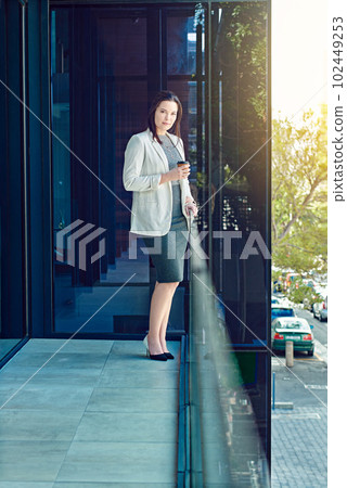Taking a micro break out on the balcony. a young businesswoman having a coffee break at work. Taking a micro break out on the balcony. a young businesswoman having a coffee break at work. 102449253