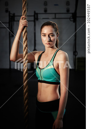 Push yourself, its so worth it. a young woman doing rope climbing. 102449587