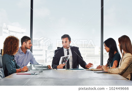 The teams talking strategy. a group of businesspeople in a meeting. The teams talking strategy. a group of businesspeople in a meeting. 102449666