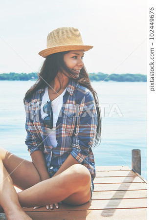Just taking it all in...an attractive young woman enjoying a day on the beach. Just taking it all in...an attractive young woman enjoying a day on the beach. 102449676