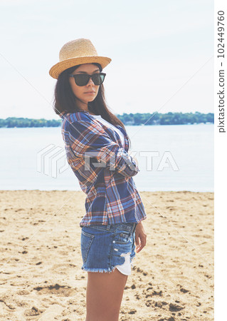 The beach is my home away from home. an attractive young woman enjoying a day on the beach. The beach is my home away from home. an attractive young woman enjoying a day on the beach. 102449760