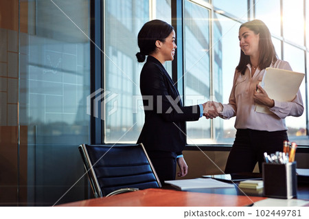 Well do great things together. two young lawyers having a conversation in their office. Well do great things together. two young lawyers having a conversation in their office. 102449781