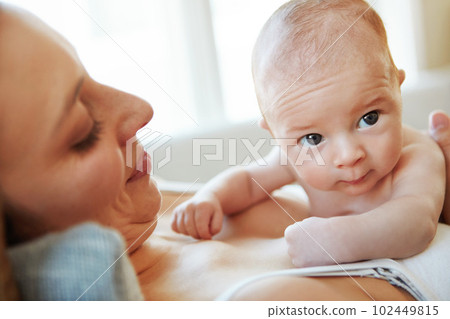 He always brightens up her day. Closeup shot of a mother lying down with her newborn baby on top of her. He always brightens up her day. Closeup shot of a mother lying down with her newborn baby on top of her. 102449815