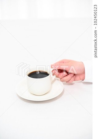 Women's hand with a cup of coffee Women's hand with a cup of coffee 102450123