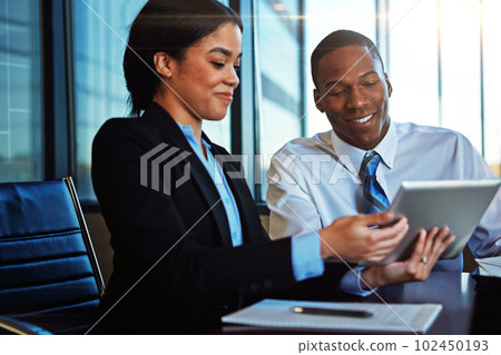 Sharing her business insight. two young businesspeople meeting in the boardroom. Sharing her business insight. two young businesspeople meeting in the boardroom. 102450193