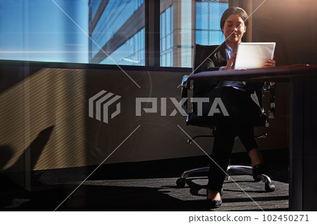You cant do anything without action. a young woman using her digital tablet at her desk. You cant do anything without action. a young woman using her digital tablet at her desk. 102450271