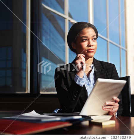 Know what you want to do and follow that ambition. a young woman contemplating while using her digital tablet. 102450279