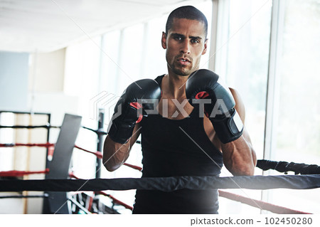 Its all about the will and the skill. Portrait of a young man training in a boxing ring. 102450280