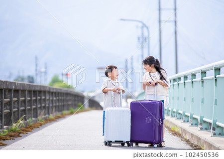 A smiling child with a suitcase trip A smiling child with a suitcase trip 102450536