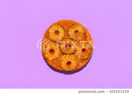 Pineapple cake top view, isolated on a purple background 102451439