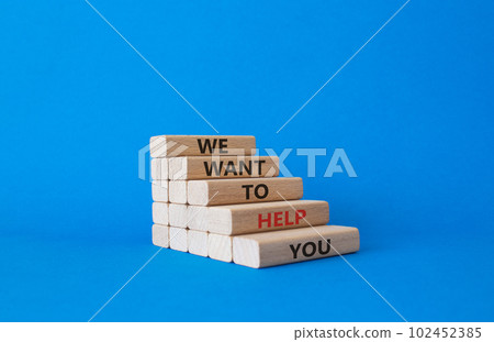We want to help you symbol. Wooden blocks with words We want to help you. Beautiful blue background. Business and We want to help you concept. Copy space. 102452385