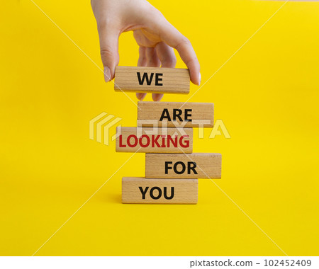 Tell us what you think symbol. Wooden blocks with words Tell us what you think. Beautiful yellow background. Businessman hand. Business and Tell us what you think concept. Copy space. 102452409