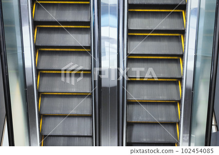 Top view on double escalator with opposite direction in the interior of a public building 102454085