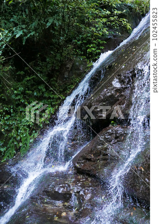 waterfall in the mountains, splashing water 102455823