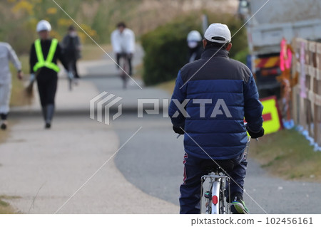 騎自行車的人在公園長廊上奔跑 騎自行車的人在公園長廊上奔跑 102456161