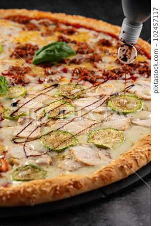 Big assorted pizza with variety of toppings Big assorted pizza with variety of toppings 102457117