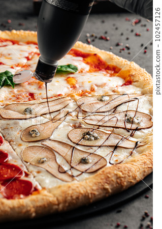 Assorted four seasons pizza variety of toppings Assorted four seasons pizza variety of toppings 102457126