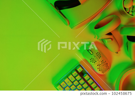 Modern gaming accessories on green desk 102458675