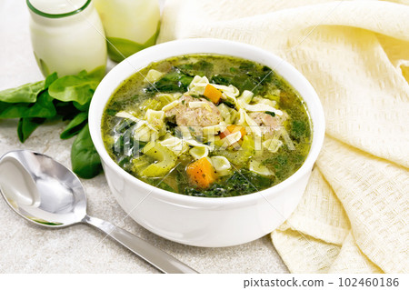 Soup with meatballs and pasta in bowl on stone Soup with meatballs and pasta in bowl on stone 102460186