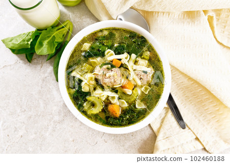 Soup with meatballs and pasta in bowl on stone top Soup with meatballs and pasta in bowl on stone top 102460188
