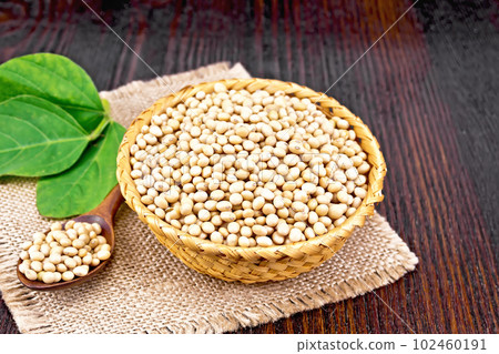 Soybeans in wicker bowl with leaf on dark board Soybeans in wicker bowl with leaf on dark board 102460191