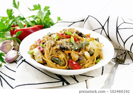 Spaghetti buckwheat with vegetables in plate on board Spaghetti buckwheat with vegetables in plate on board 102460192