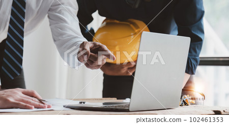 Architect team working with blueprints for architectural plan, engineer sketching a construction project, green energy concept 102461353