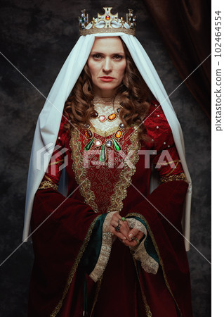 medieval queen in red dress with veil and crown 102464554