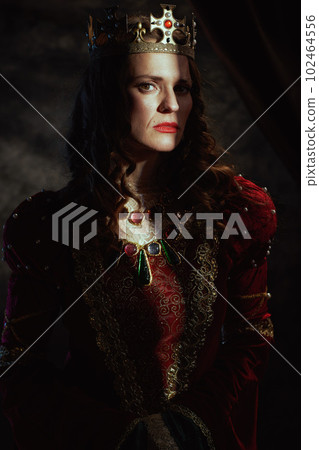 medieval queen in red dress with crown 102464556