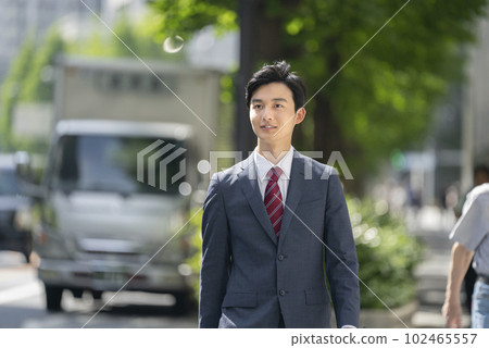 Young businessman portrait walking in the city 102465557
