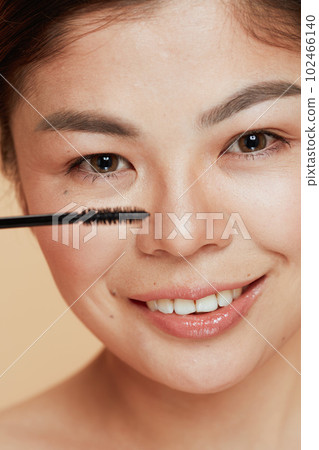young asian female with mascara 102466140