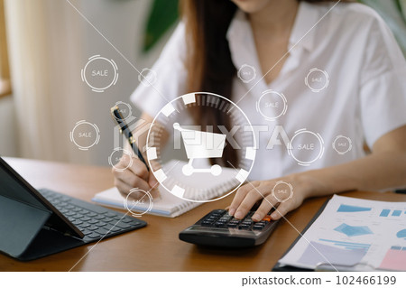 Business woman pressing promotion and calculating delivery at office desk in the morning. 102466199