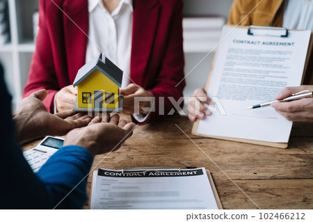 Considering buying a home, investing in real estate. Broker signs a sales agreement. agent, lease agreement, successful deal Considering buying a home, investing in real estate. Broker signs a sales agreement. agent, lease agreement, successful deal 102466212