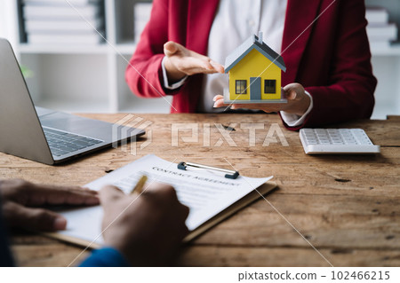 Considering buying a home, investing in real estate. Broker signs a sales agreement. agent, lease agreement, successful deal Considering buying a home, investing in real estate. Broker signs a sales agreement. agent, lease agreement, successful deal 102466215