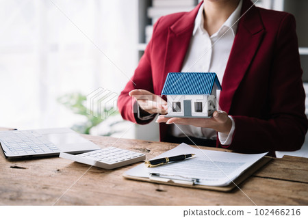 Considering buying a home, investing in real estate. Broker signs a sales agreement. agent, lease agreement, successful deal 102466216