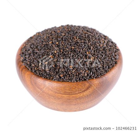 Basil seeds in wooden bowl, isolated on white background. Ocimum basilicum. Basil seeds in wooden bowl, isolated on white background. Ocimum basilicum. 102466231