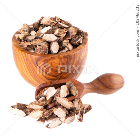 Calamus root in wooden bowl and spoon, isolated on white background. Sweet flag, sway or muskrat root. Dry root of Acorus calamus. Calamus root in wooden bowl and spoon, isolated on white background. Sweet flag, sway or muskrat root. Dry root of Acorus calamus. 102466235