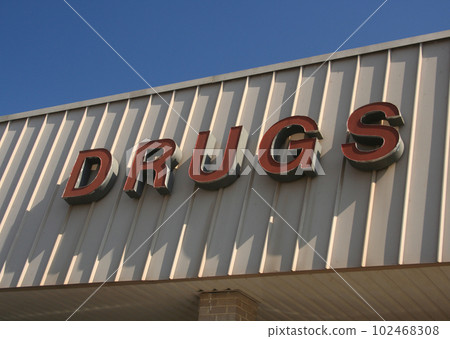 Vintage Drugs Sign on Outside of Retail Market Store 102468308
