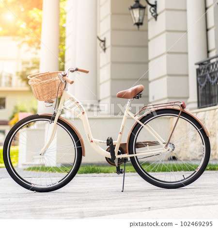 View of urban city bicycle parked on street in neighborhood. Sun bike summer. No people. 102469295
