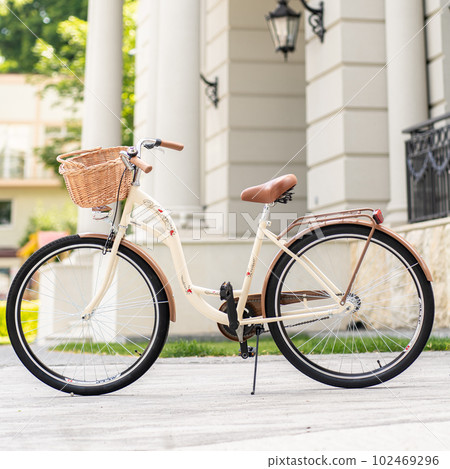 View of urban city bicycle parked on street in neighborhood. Sun bike summer. No people. 102469296