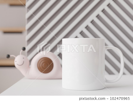 White kids mug mock up. Blank template for your design, advertising, logo. Close-up view. Copy space. Cup standing in children room. Playful cup mockup. 3D rendering. White kids mug mock up. Blank template for your design, advertising, logo. Close-up view. Copy space. Cup standing in children room. Playful cup mockup. 3D rendering. 102470965