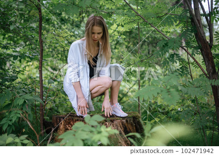 Girl in green forest. Practice of meditation and interaction with nature Girl in green forest. Practice of meditation and interaction with nature 102471942