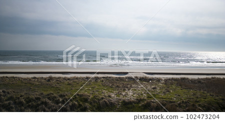 Drone over sand dunes at the beach looking at the Atlantic Ocean 102473204