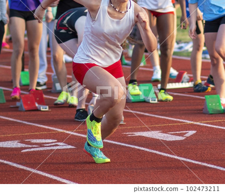 High school girl running in the 100 meter dash 102473211
