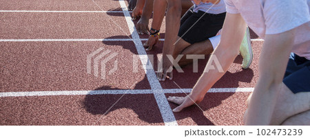 Arms of sprinters in the on your mark position at track practice Arms of sprinters in the on your mark position at track practice 102473239