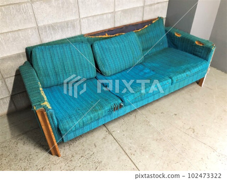 A used blue sofa sent to the junkyard A used blue sofa sent to the junkyard 102473322