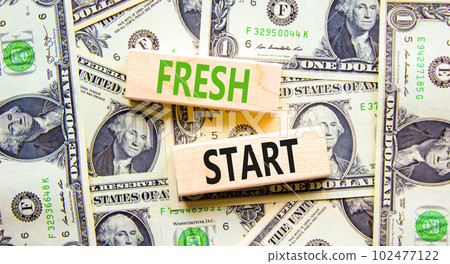 Fresh start and motivational symbol. Concept words Fresh start on beautiful wooden block. Beautiful background from dollar bills. Business motivational and Fresh start concept. Copy space. 102477122