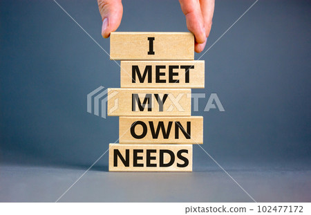 I meet my own needs symbol. Concept words I meet my own needs on wooden blocks. Businessman hand. Beautiful grey table grey background. Business and i meet my own needs concept. Copy space. 102477172
